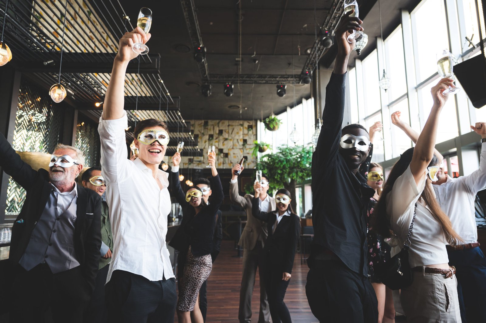 Cheers! Group of people cheering with champagne flutes in pub interior background